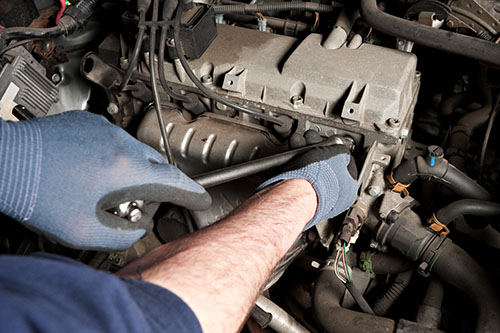 Mechanical repairs a car in the garage.